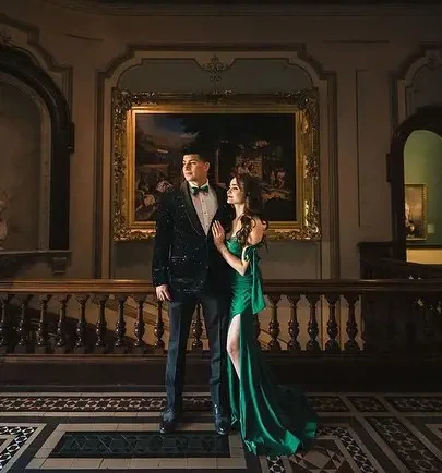 Сouple wearing a green gown and a black suit