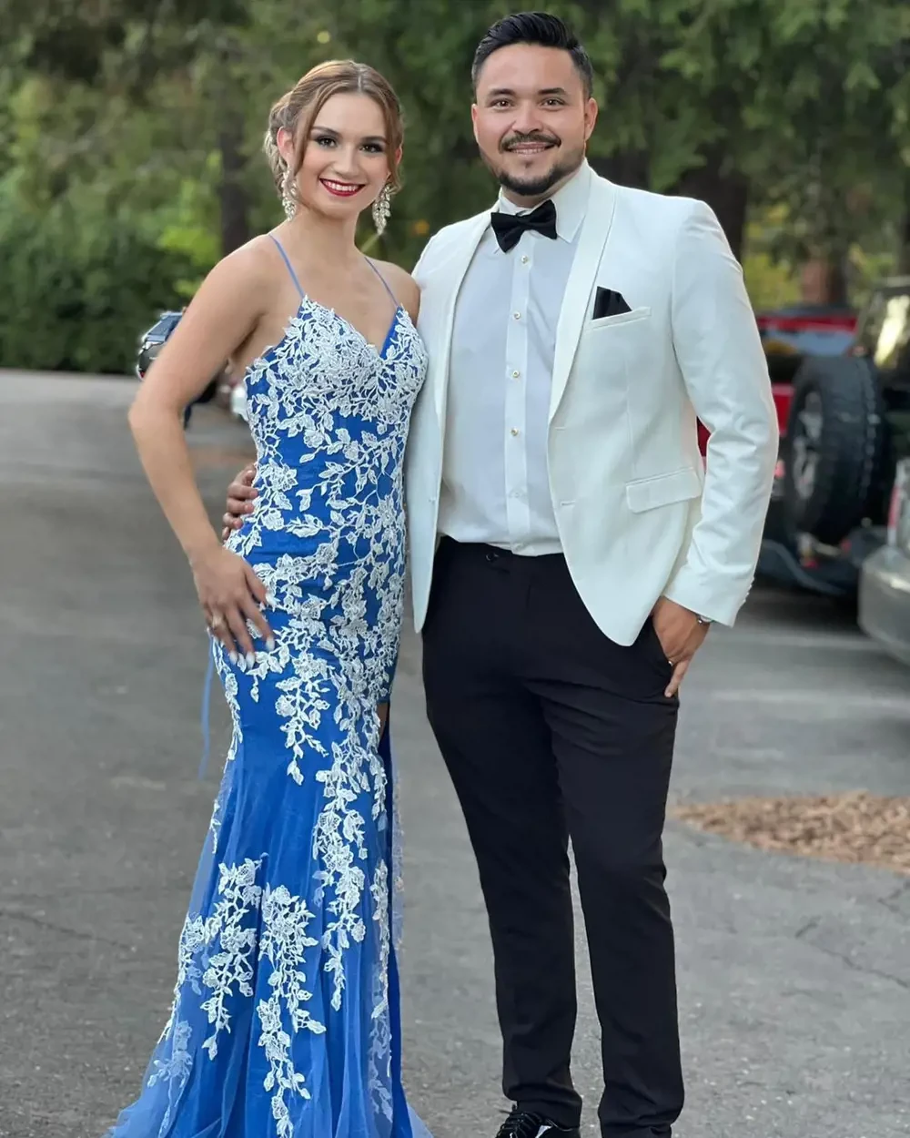 Сouple wearing a white-lue gown and a white suit