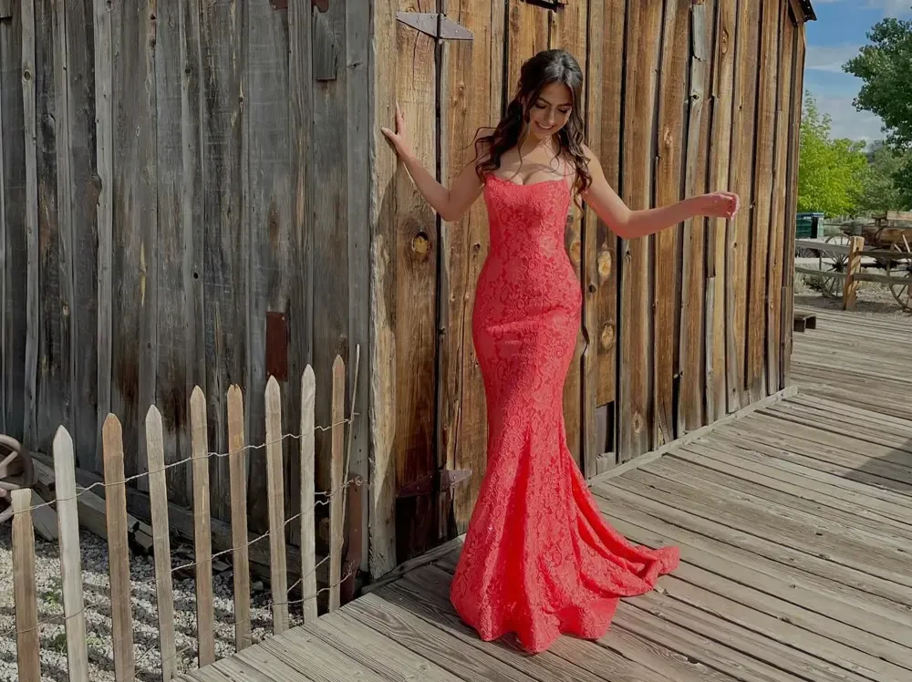 Model wearing a light-red gown