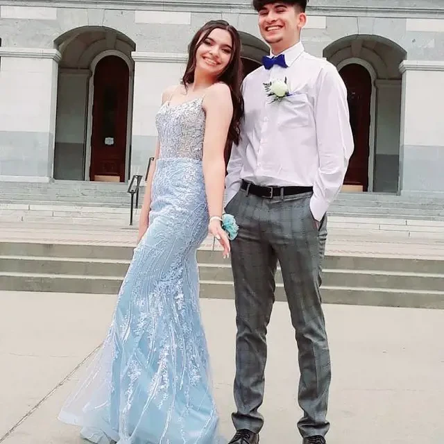 Сouple wearing a light-blue gown and a gray suit