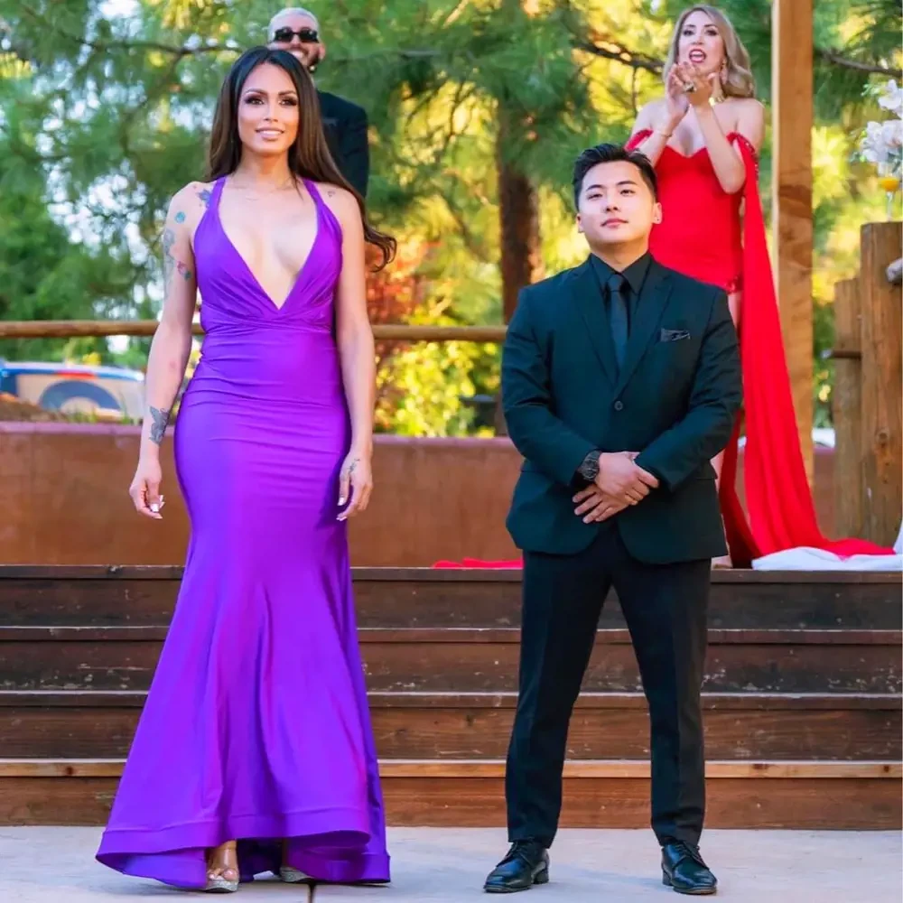 Сouple wearing a violet gown and a black suit