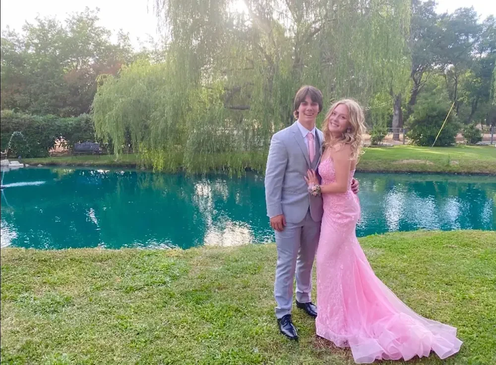Сouple wearing a pink gown and a gray suit