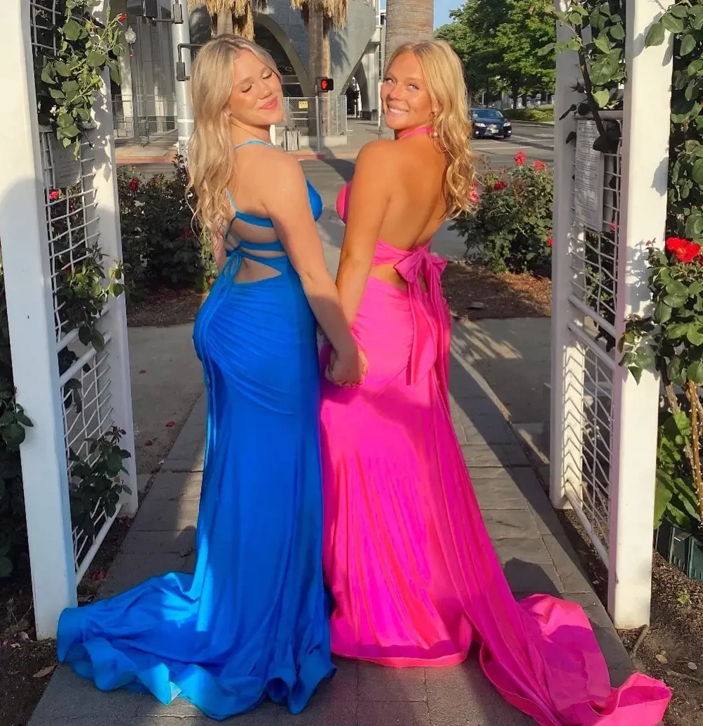 Models wearing a blue and a pink dresses