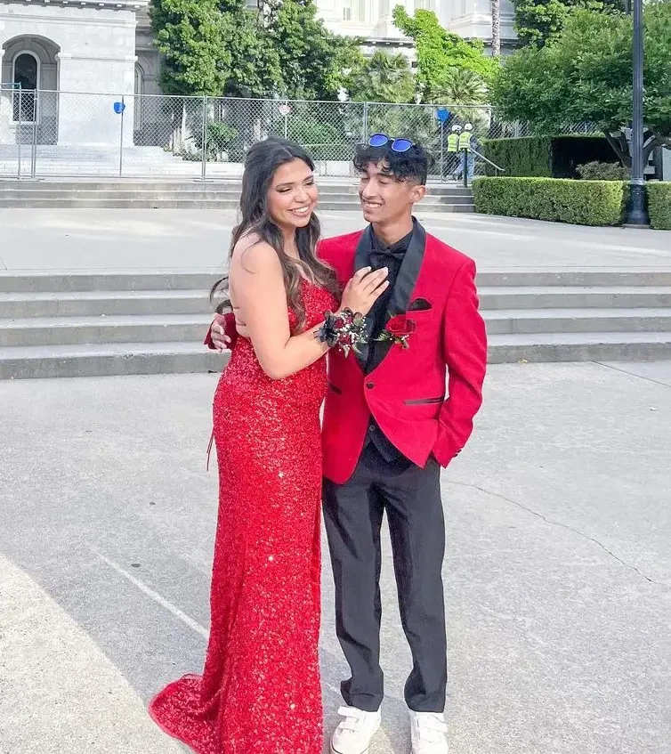 Сouple wearing a red gown and a red suit